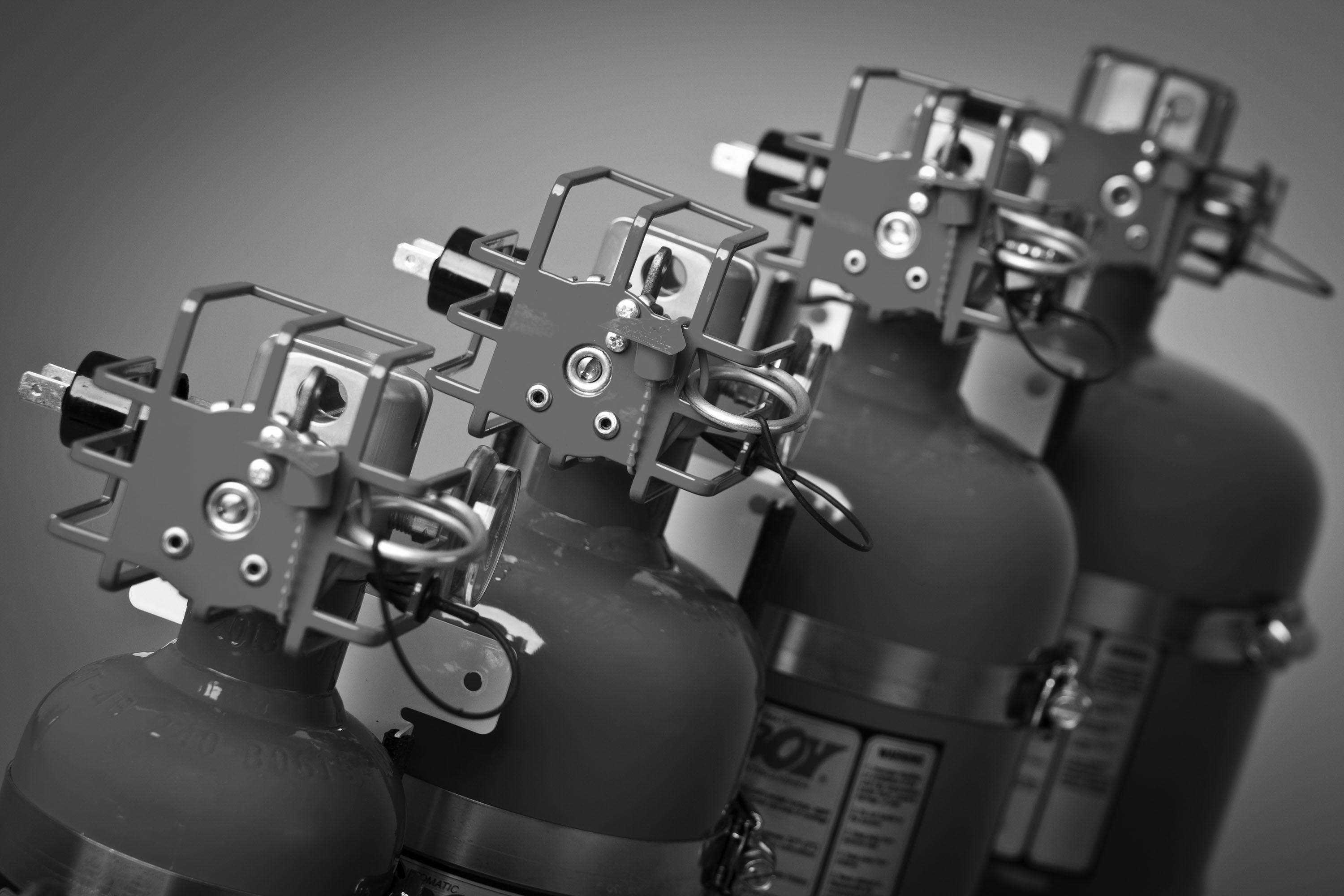 Extinguishers lined up in black and white