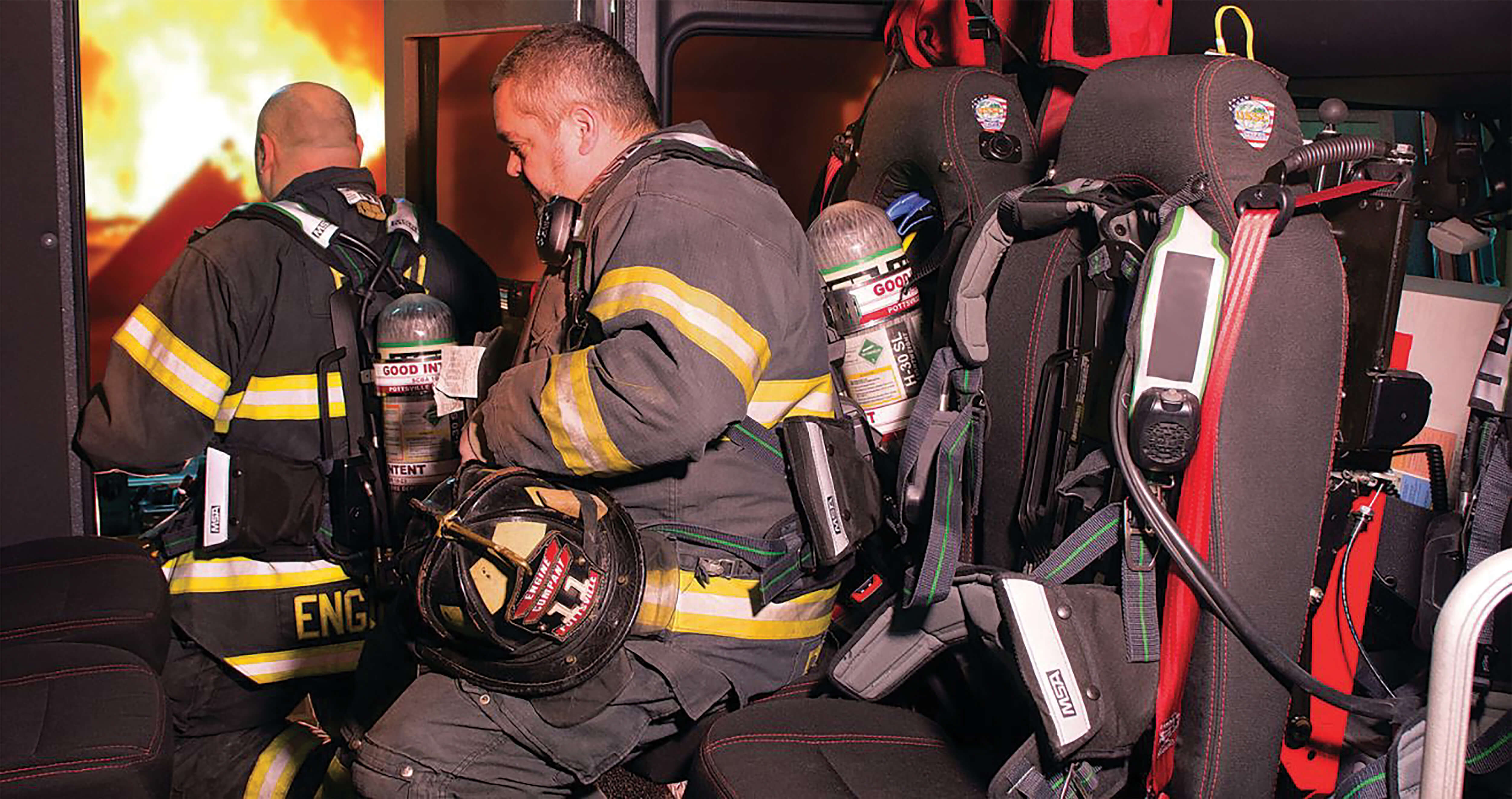 firefighters leaving their seats in the firetruck to assist with a fire