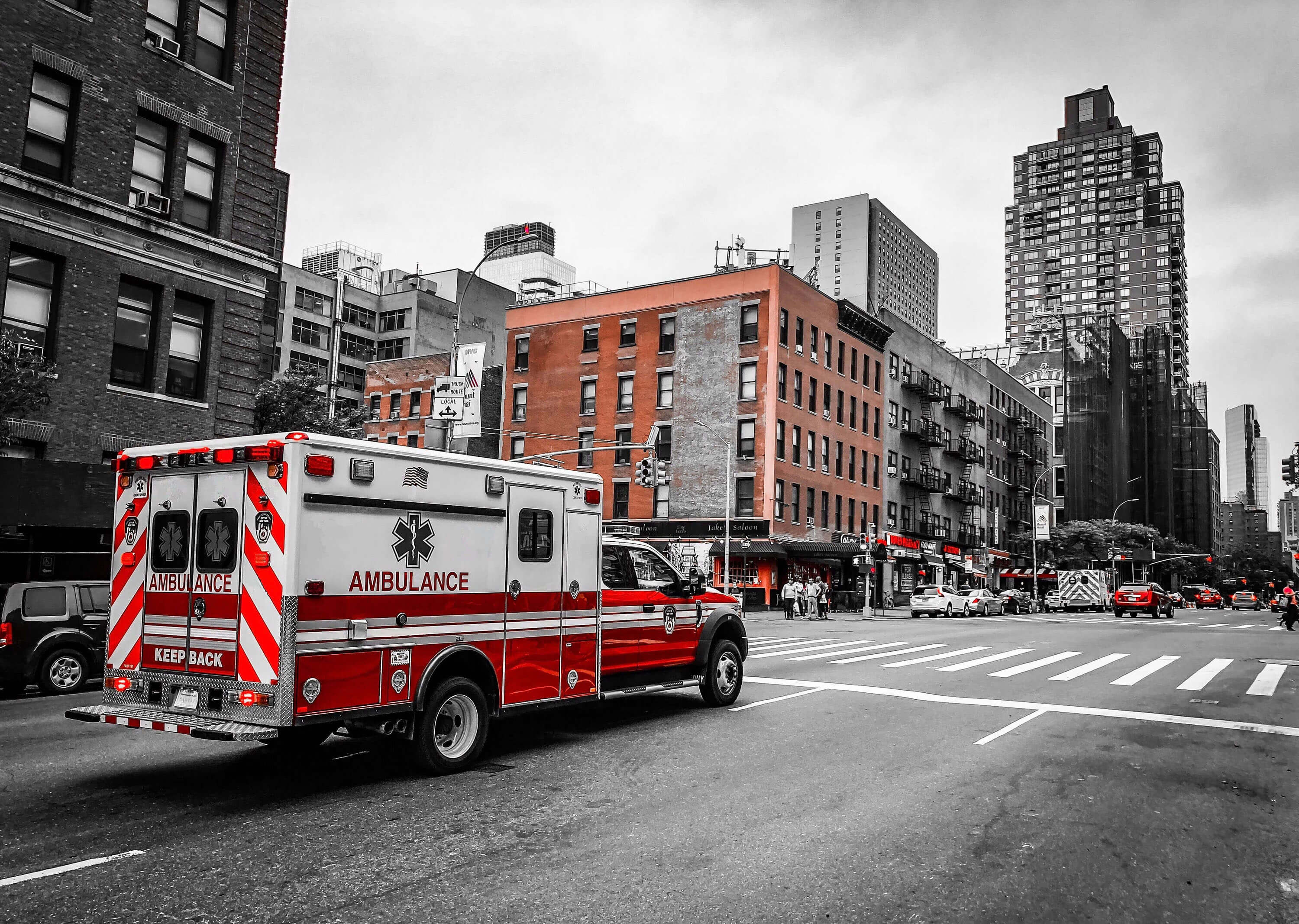 ambulance driving down a busy street