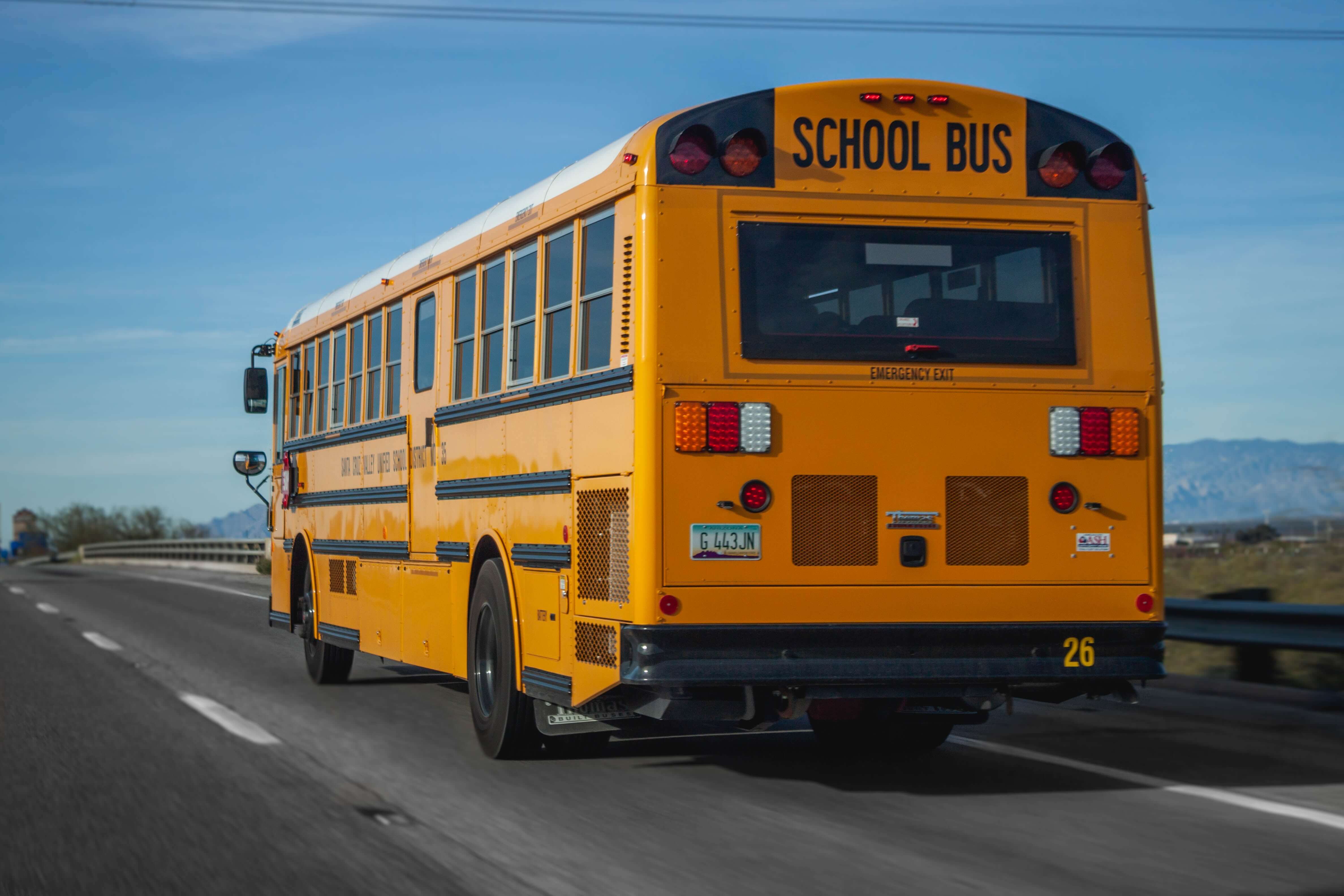 Yellow school bus driving on the highway