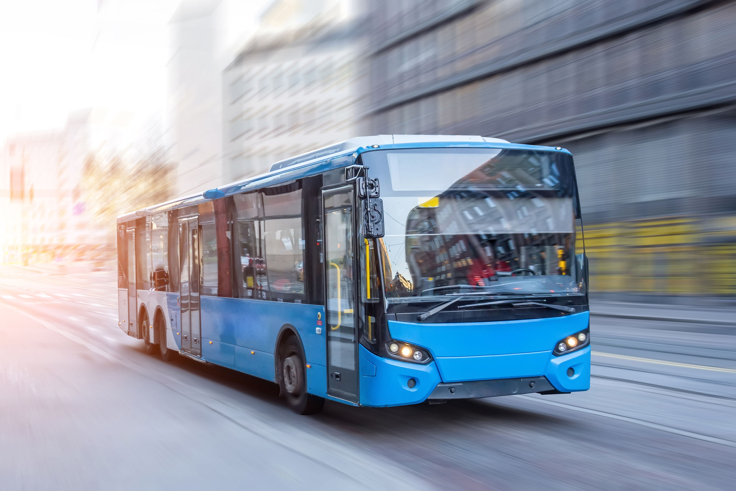 Blue bus driving in the city