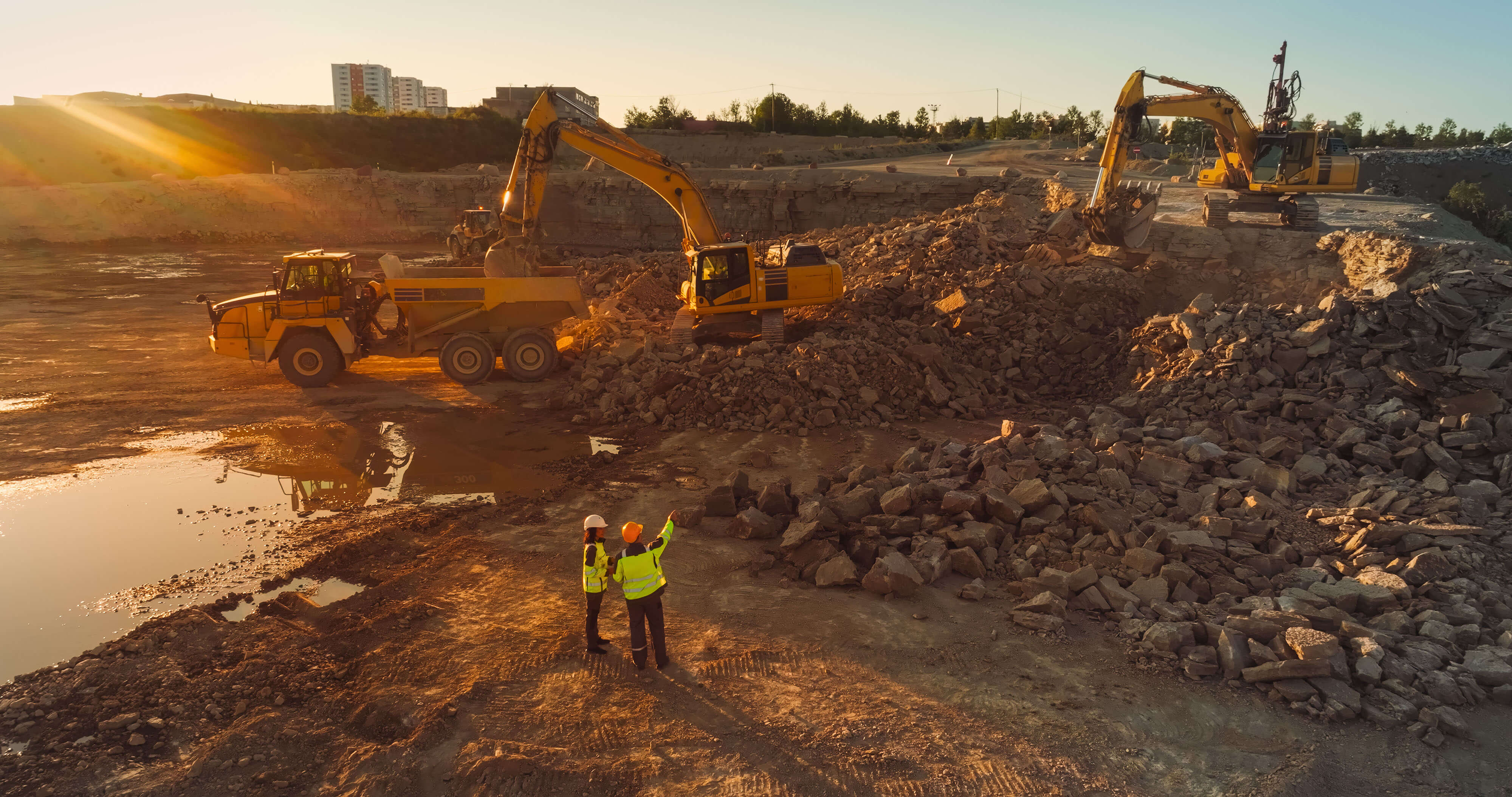 mining site with trucks and workers